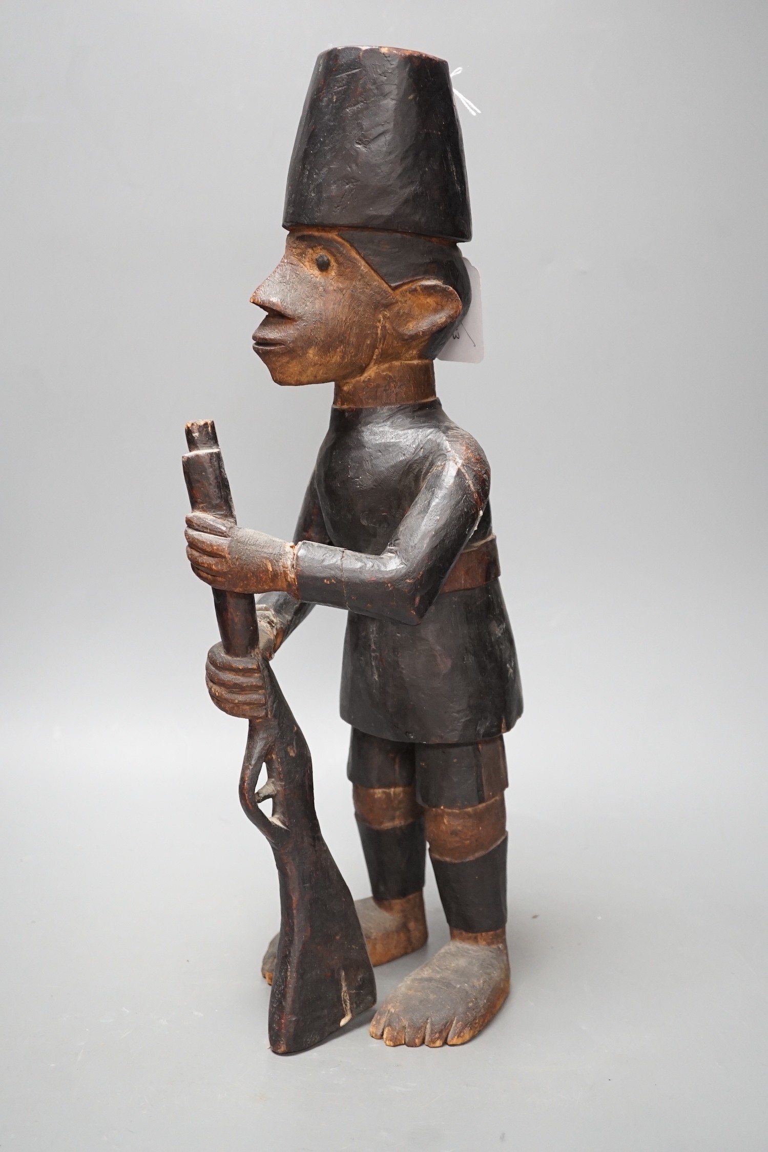 A late 19th century Belgian Congo carved wood figure of a sepoy Height 44 cm